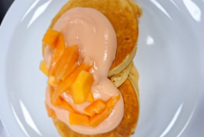Pancakes with sliced peach and a cream sauce