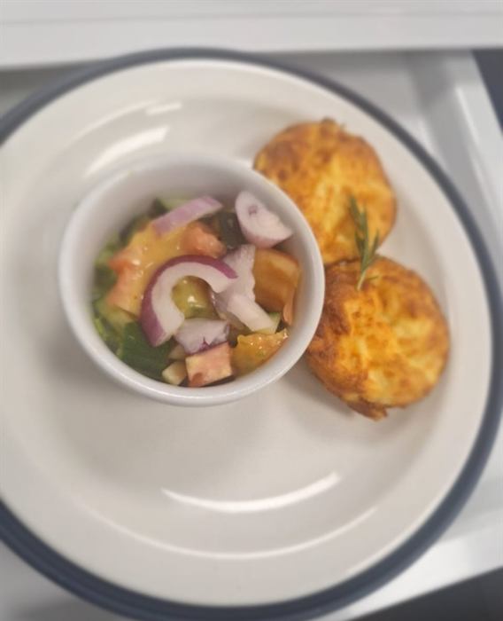 Corn fritters with a bowl of fresh tomato and onion salsa