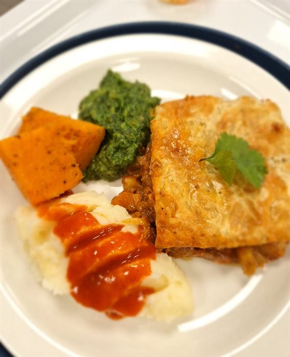 Crumbed fillet with roasted sweet potato, a green herb sauce, mash and a chilli swipe