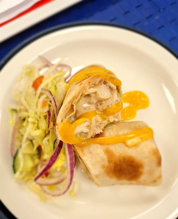 Sliced chicken wrap with crisp slaw, red onion and a mango coulis