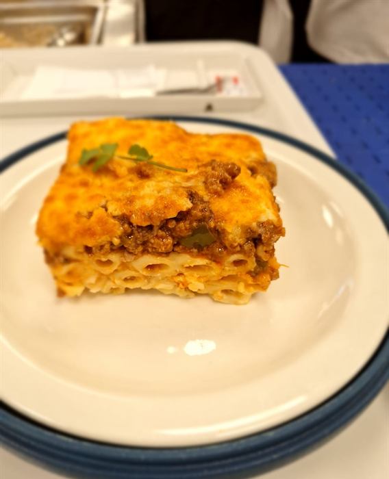 A cut portion of baked lasagne with a browned cheese top