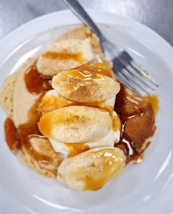 Sliced poached chicken napped with pan gravy