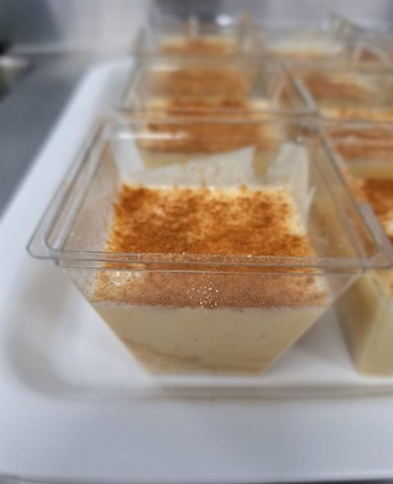 Tiramisu portions in glass dishes, dusted with cocoa