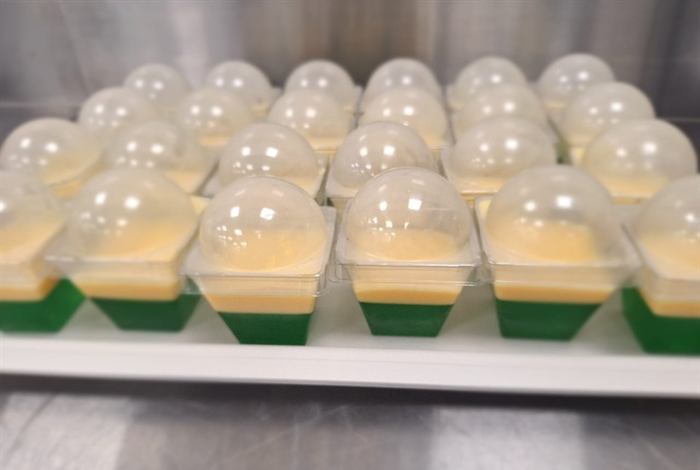 A tray of covered jelly and custard cups prepared for service