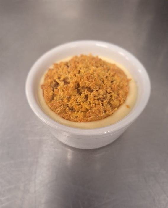 A crumble portion in custard, close on the pass