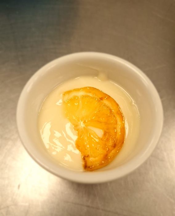 Custard topped with a peach half