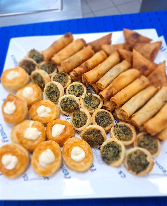 A function platter of tartlets, spring rolls and cream-topped blinis