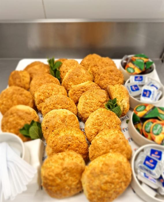 A platter of golden croquettes with dips and preserves